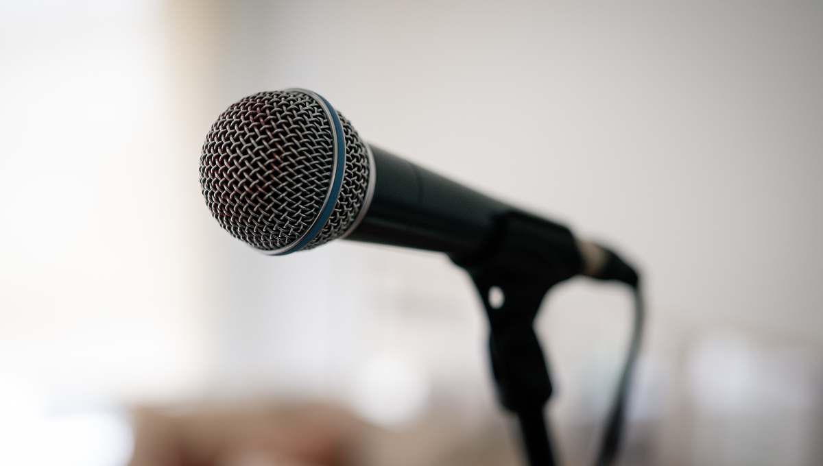 Microphone on stage, performance coaching in Melbourne